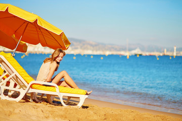 Girl relaxing on a beach chair near the sea