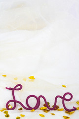 word love of red thread on fabric background