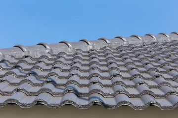 black roof tiles on house with blue sky