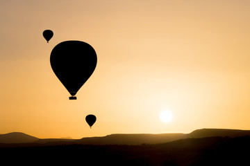 Silhouette of hot air balloons fly over Cappadocia.