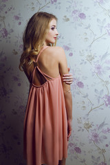 Obraz premium Emotive portrait of young beautiful woman with long blonde hair.