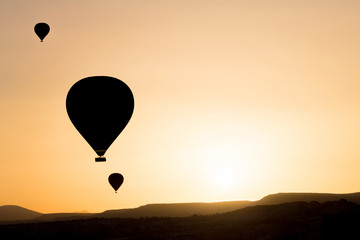 Silhouette of hot air balloons fly over Cappadocia.