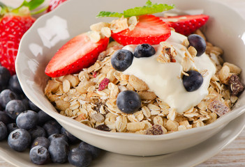 Healthy Breakfast with fresh berries, yogurt and  muesli.