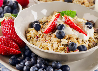 Breakfast with  berries, yogurt and  muesli.