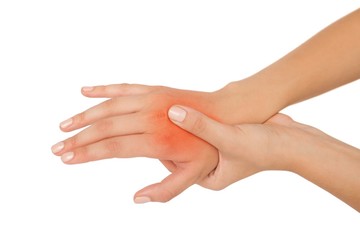 Young woman touching her injured hand