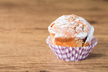 homemade muffins over wooden board selective focus