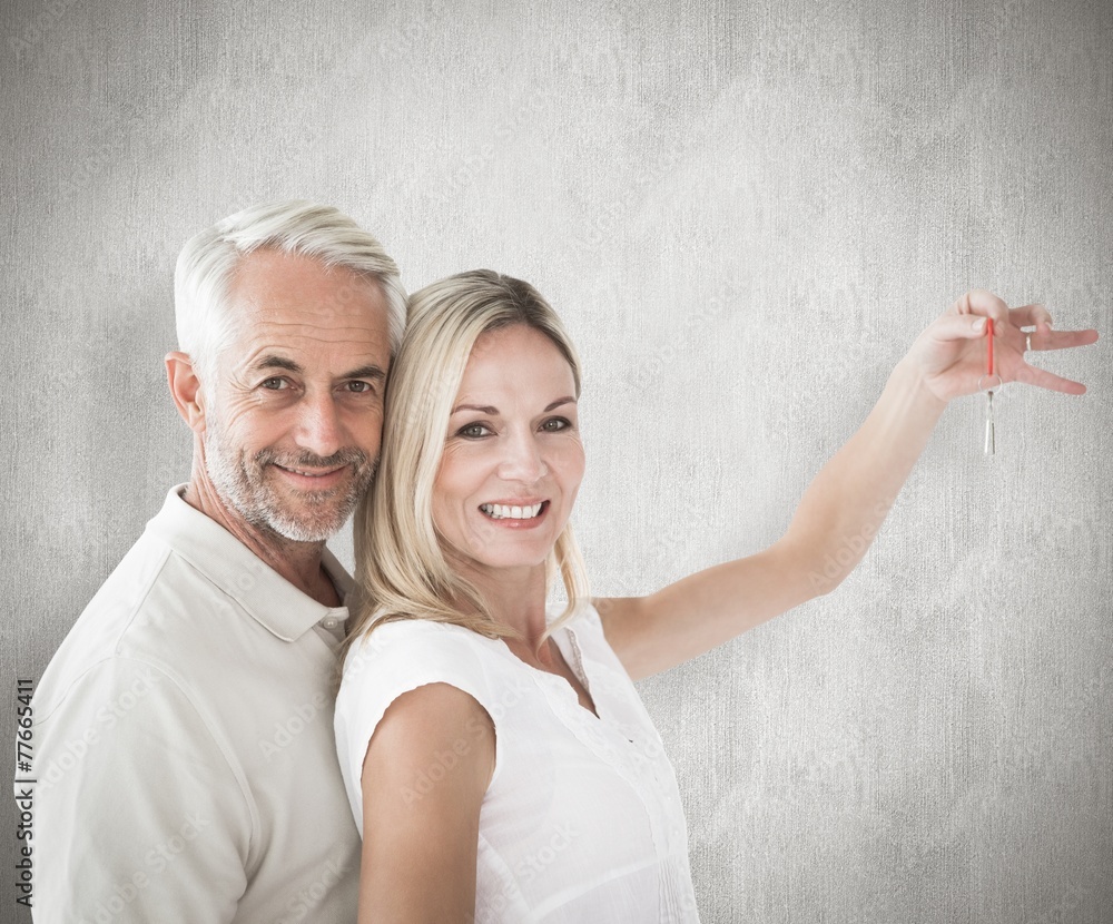 Poster composite image of happy couple showing their new house key