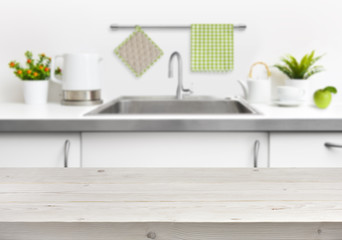 Wooden table on kitchen sink interior background