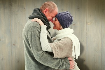 Happy mature couple in winter clothes embracing