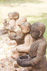 Fototapeta na wymiar Little monk clay doll decorated in garden
