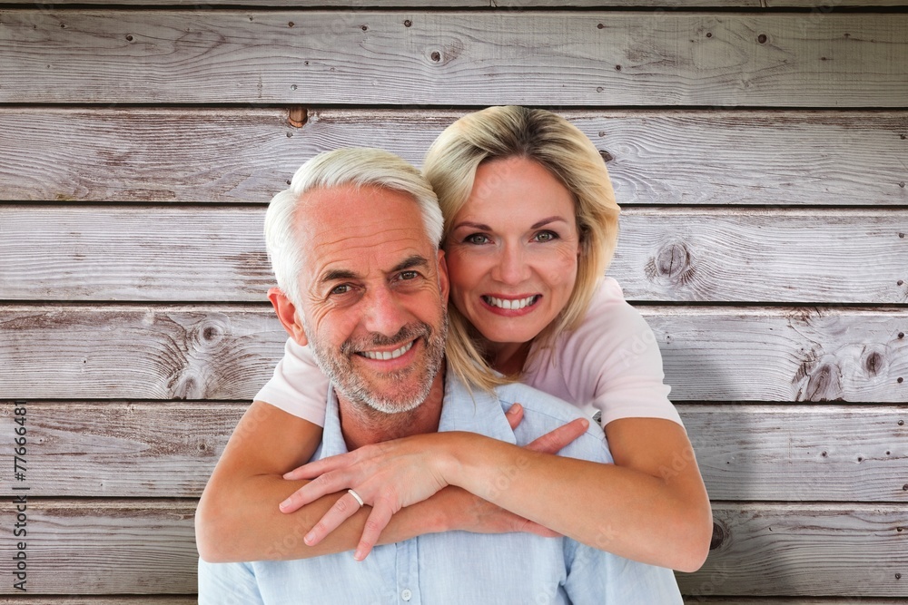 Poster smiling couple embracing and looking at camera
