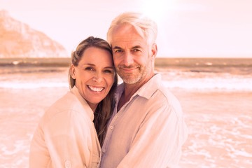 Happy couple hugging on the beach