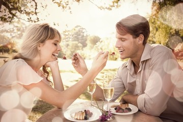 Cute couple feeding each other dessert