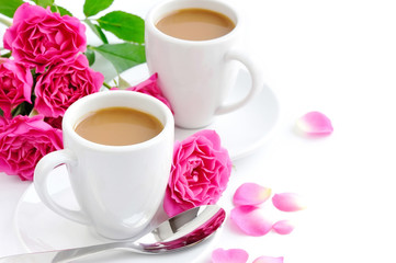 Cups of coffee and pink roses on white background