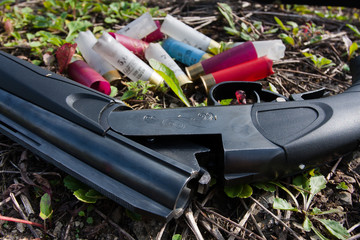 shotgun and cartridges on the ground