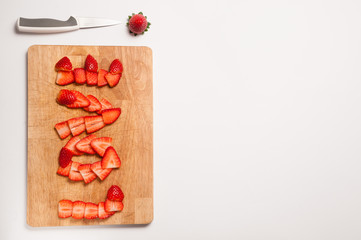 love write with strawberry on cutting board and a knife