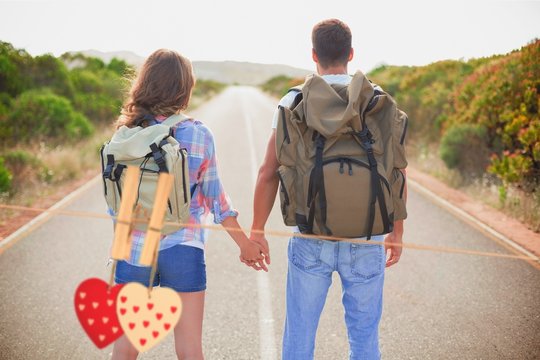 Composite image of hiking couple standing on countryside road