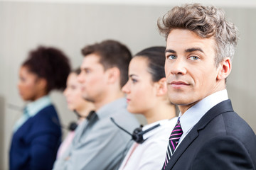 Confident Manager With Employees Standing In Row