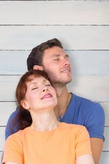 Fototapeta premium Composite image of happy couple together looking upwards