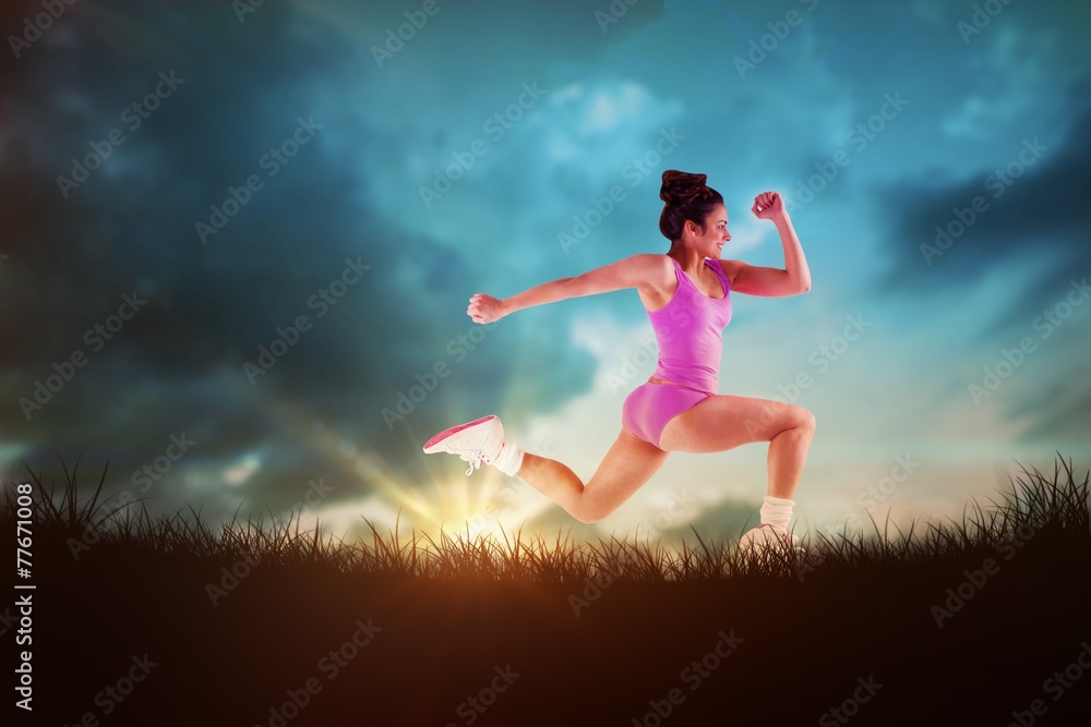 Poster Composite image of fit brunette running and jumping