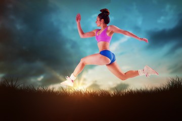 Fototapeta na wymiar Composite image of fit brunette running and jumping