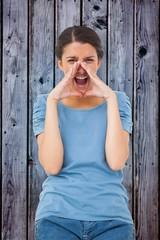 Fototapeta premium Composite image of pretty brunette shouting