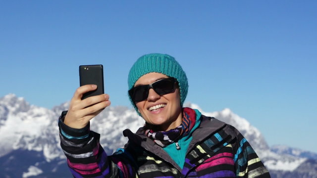 Young female taking a self-portrait with her smartphone