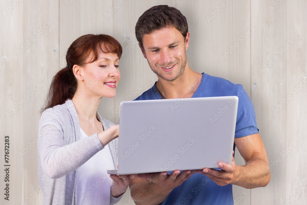 Poster composite image of couple using a laptop together