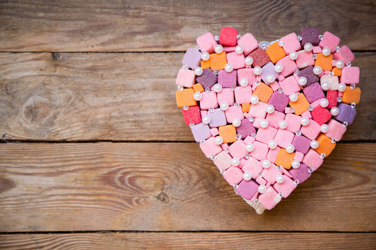 handmade multicolored heart on wood background