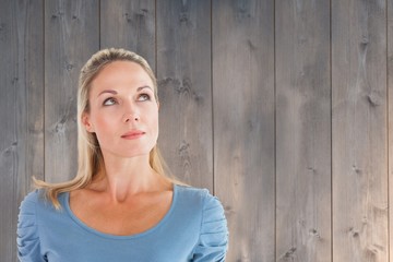 Composite image of thinking pretty blonde looking up