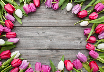 tulips arranged on old wooden background