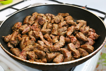 beef liver bits on a pan