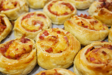 rolled baking of puff-paste with cheese and ham