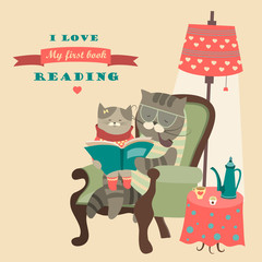 Cat and kitten reading book
