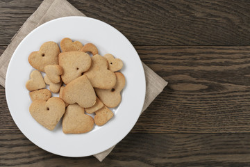 heart cookies for valentines day in plate on wood table