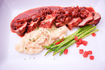 meat table with fried beef, asparagus served  and potatoes mash