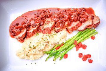meat table with fried beef, asparagus served  and potatoes mash
