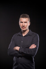 a man in a black shirt on a black background
