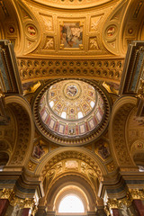 The golden dome and interior inside the church in Budapest