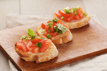 simple italian appetizing bruschetta with tomato and basil, on