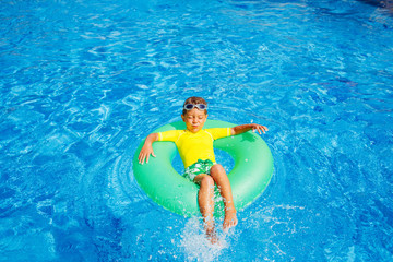 Boy swims in a pool