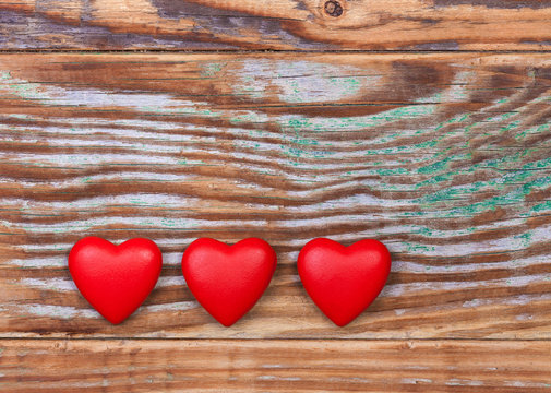Red hearts on grunge wooden background