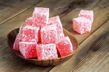 Red  and white Turkish Delight with coconut in a wooden bowl 