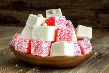 Red  and white Turkish Delight with coconut in a wooden bowl 
