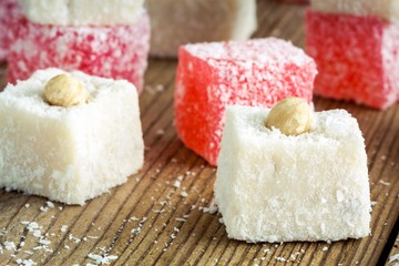 Red  and white Turkish Delight with coconut in a wooden bowl 