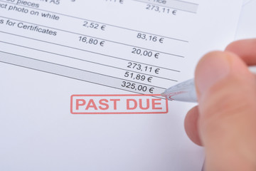 Person's Hand Over Past Due Statement