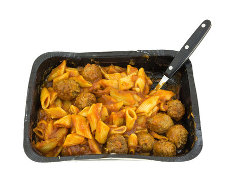 Penne pasta with meatballs in serving tray TV dinner.