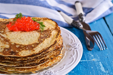 A stack of pancakes with red caviar