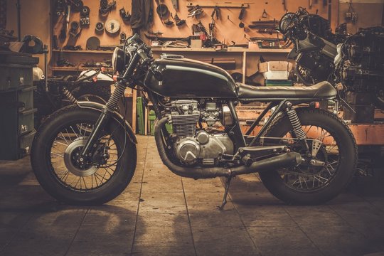 Fototapeta Vintage style cafe-racer motorcycle in customs garage