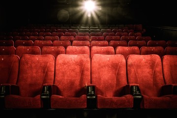 Empty comfortable red seats with numbers in cinema - obrazy, fototapety, plakaty